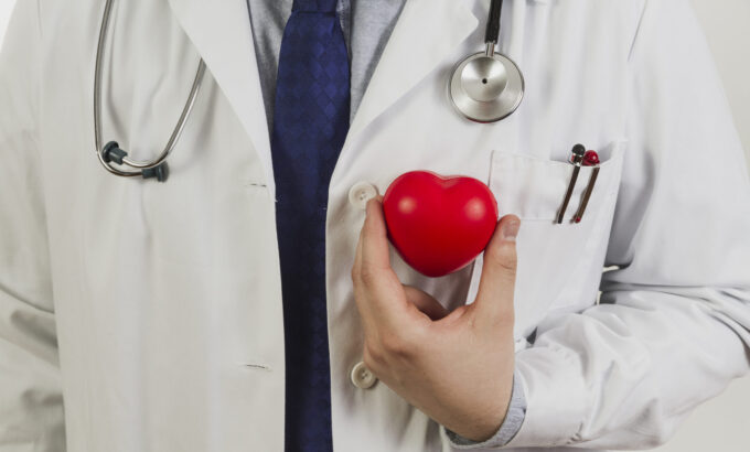 doctor-showing-plastic-heart