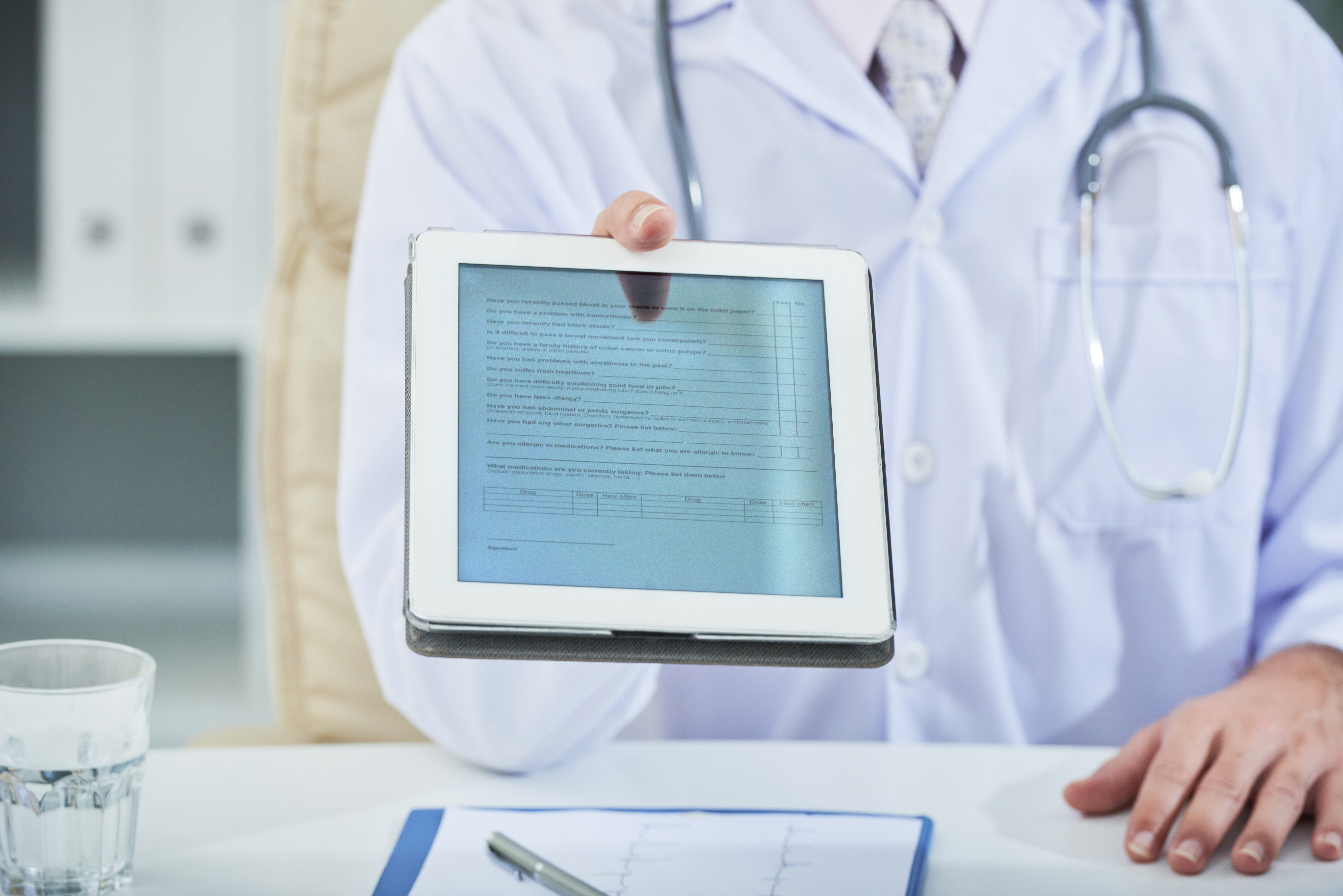 Digital tablet with survey in hands of doctor